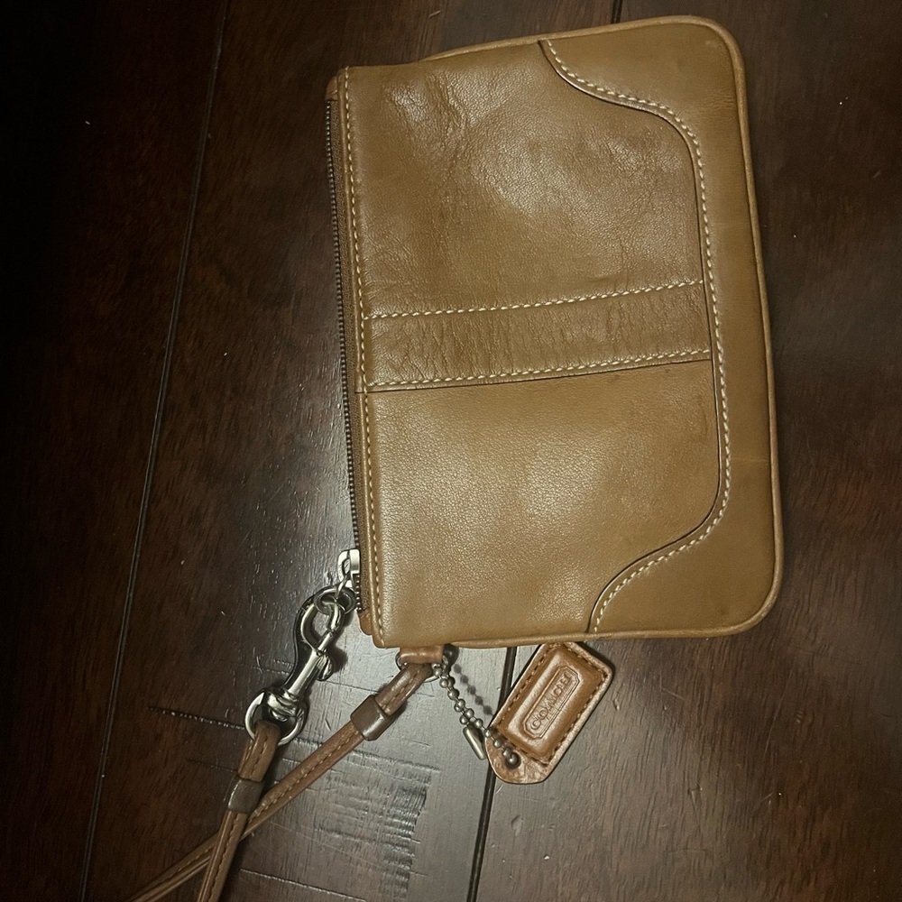 Light brown Coach wristlet with silver hardware